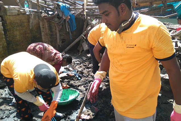 Volunteers from Jet Airways helping clean houses on Appasamy Street, Chennai